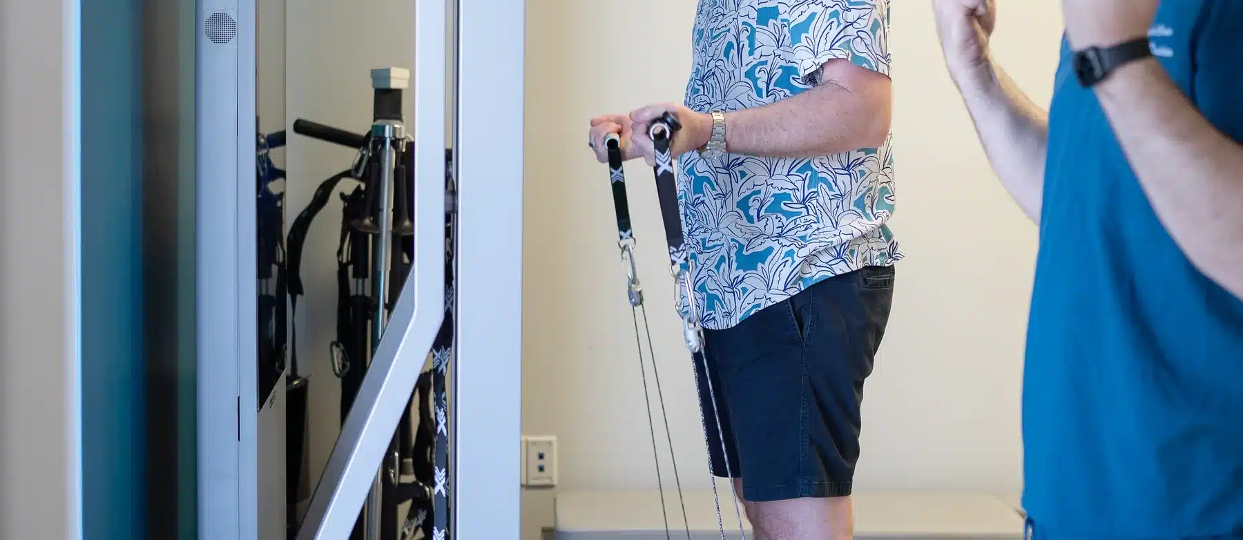 A patient working on a computer-controlled resistance training system during a rehabilitation session at HealthSpine Chiropractic in Carrollwood, Tampa.