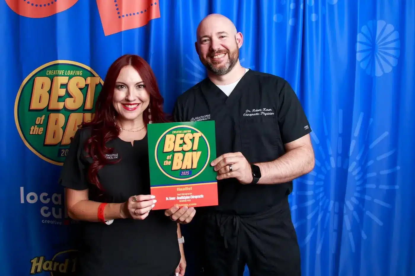 Dr. Bobby Koser, DC, and a HealthSpine Chiropractic team member holding the Creative Loafing Best of the Bay 2025 certificate at the awards event. The certificate reads: Finalist, Best Chiropractor, Dr. Koser, HealthSpine Chiropractic, Readers Pick.