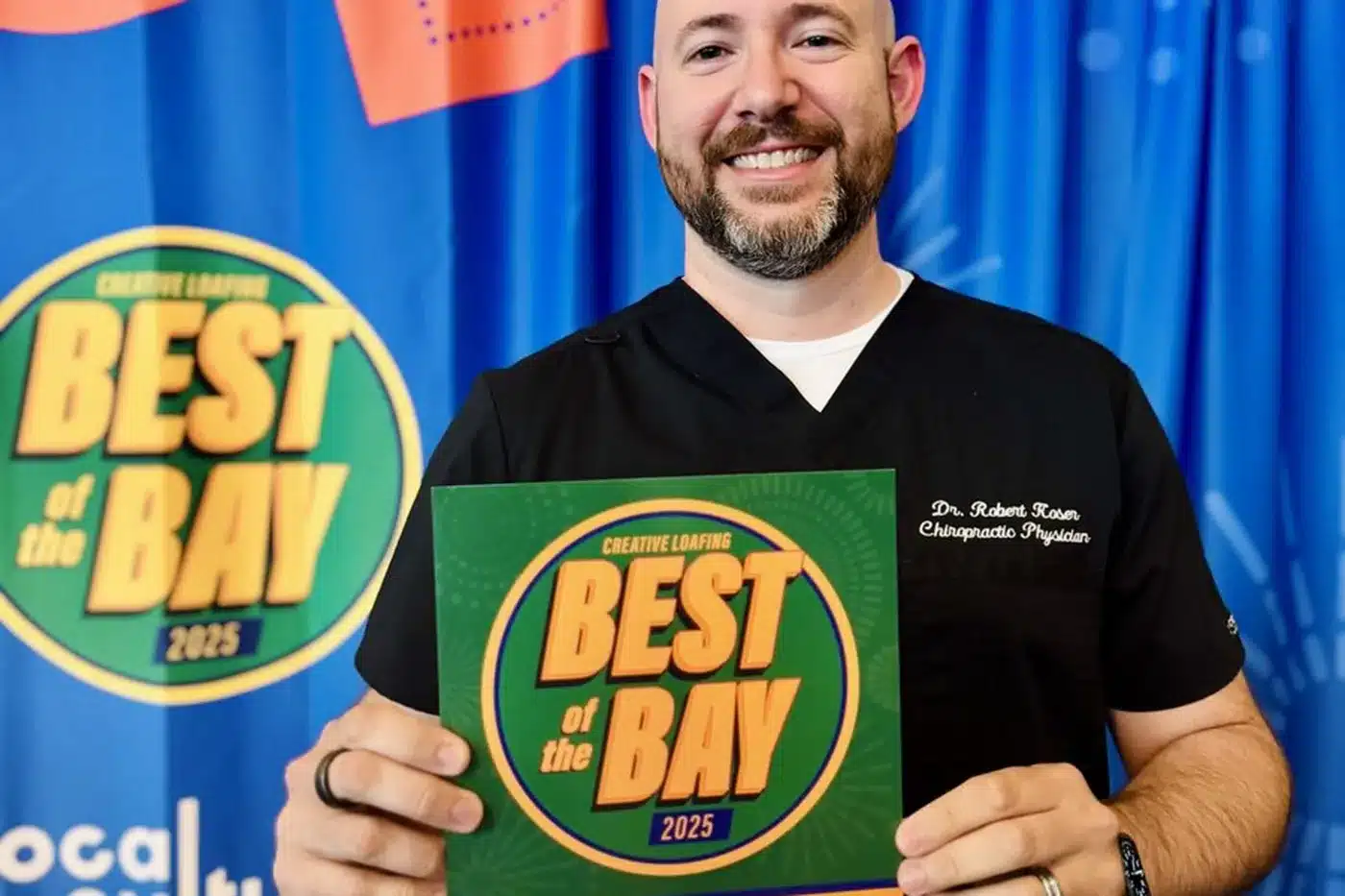 Dr. Bobby Koser, DC, chiropractic physician, holding the plaque Creative Loafing issued. It reads: Finalist, Best Chiropractor, Creative Loafing Best of the Bay 2025, Readers Pick.