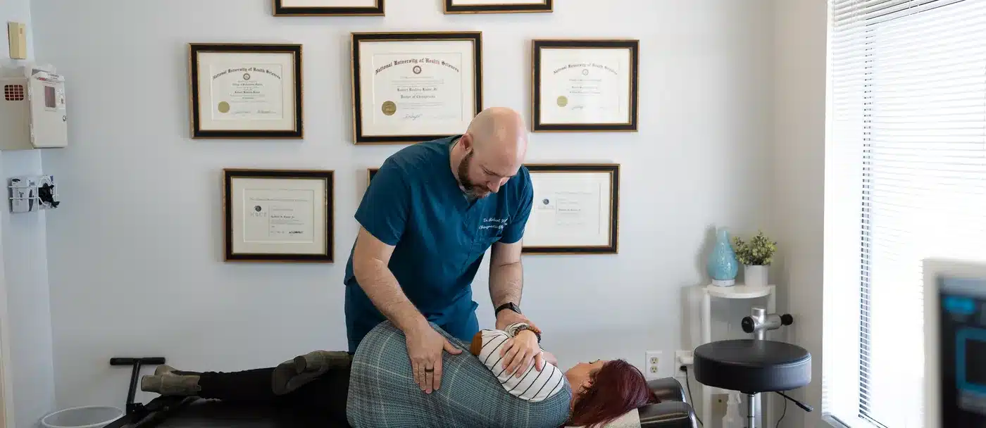 Dr. Bobby Koser, DC, chiropractic physician, performing a hands-on spinal adjustment at HealthSpine Chiropractic in Carrollwood, Tampa.