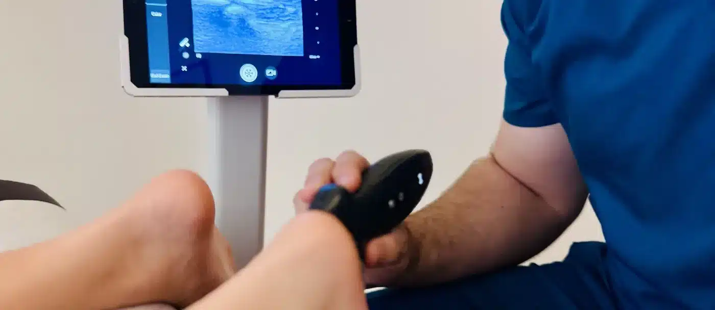 Dr. Bobby Koser, DC, chiropractic physician, using diagnostic ultrasound to view the plantar fascia of a patient's foot at HealthSpine Chiropractic in Carrollwood, Tampa.