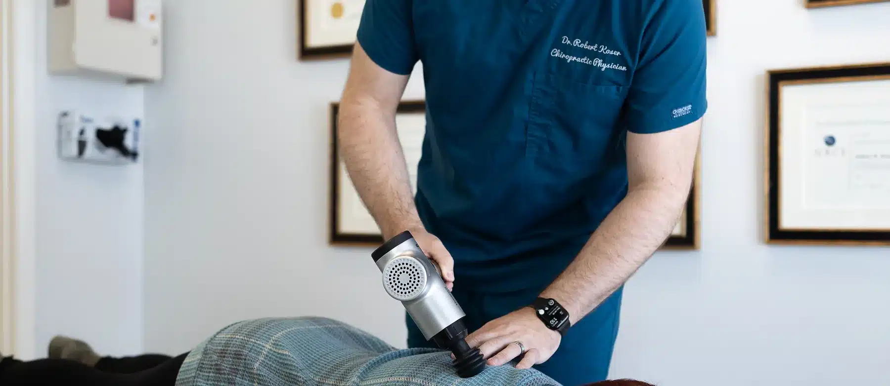 Dr. Bobby Koser, DC, chiropractic physician, working on a patient&rsquo;s upper back at HealthSpine Chiropractic in Carrollwood, Tampa.